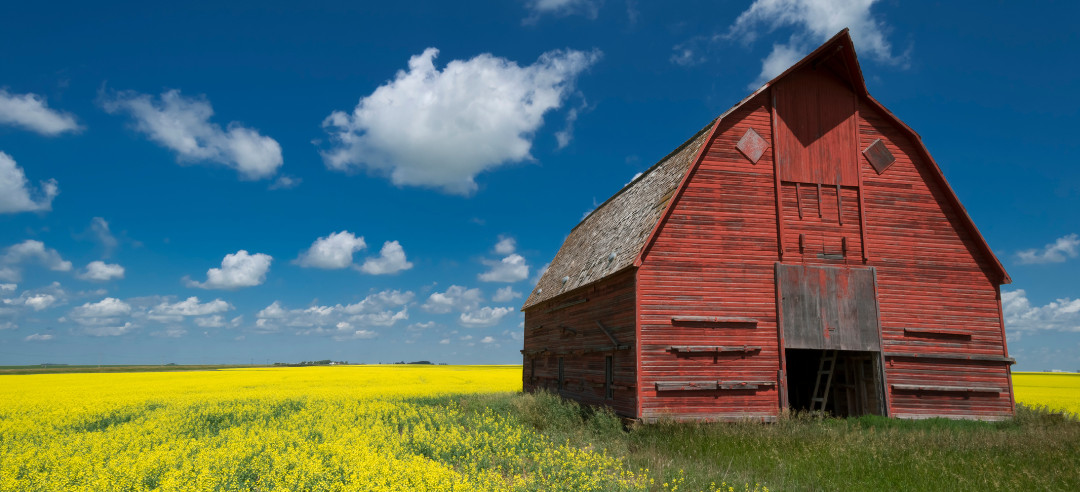 A red barn in an open field 